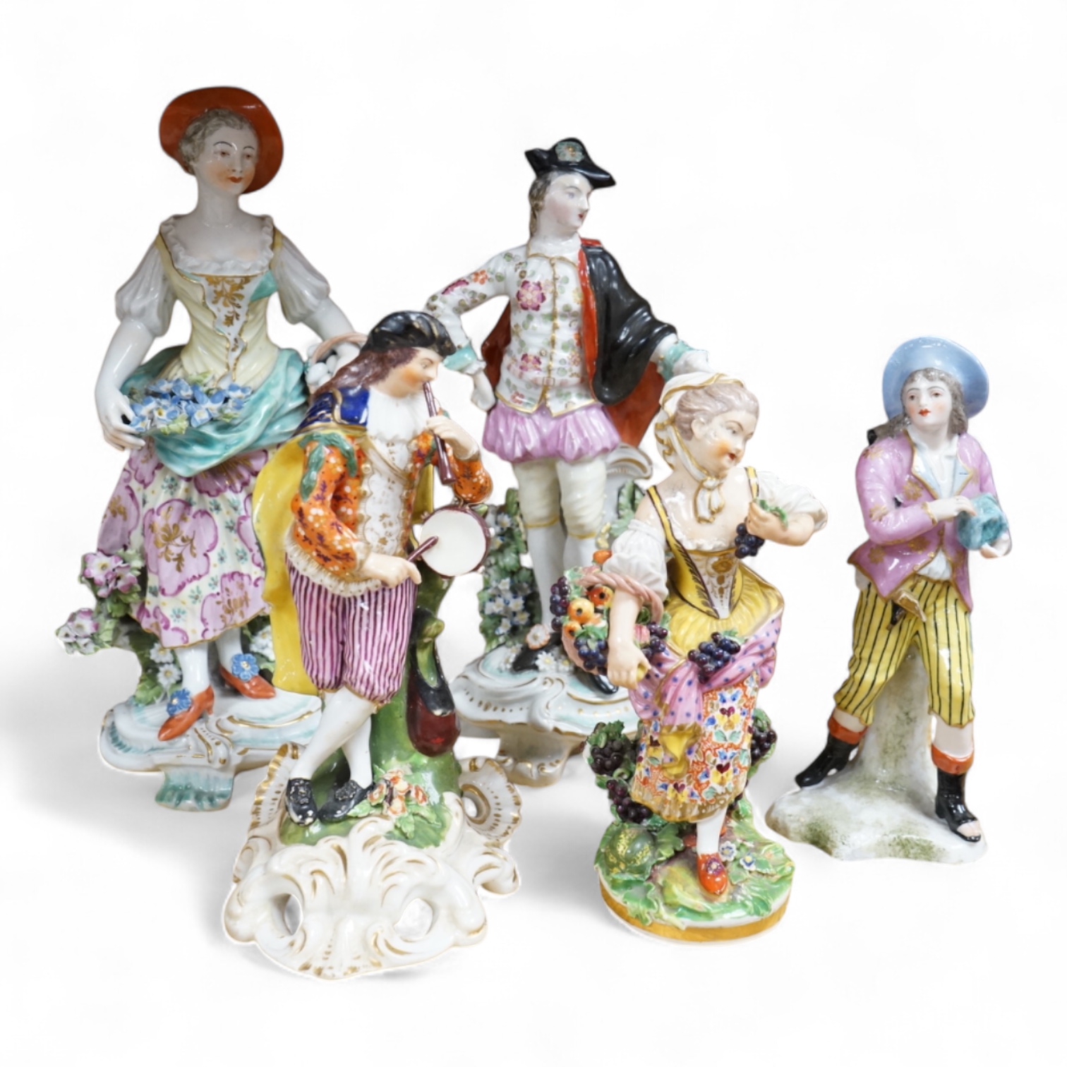 Three late 18th century Derby figures, a similar Derby figure of Summer, c.1810–30 and a Derby style figure of a street vendor, tallest 26cm high